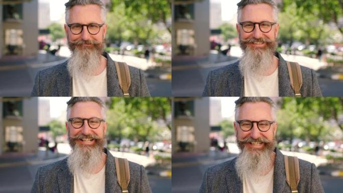 快乐的成熟男性潮人在城市里欢笑。一个自信而古怪的教授或商人的肖像，留着胡须和眼镜，在镇上感觉积极，心
