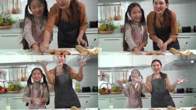 亚洲母女俩互相帮助做面包或在厨房里烤得很开心。反映了母亲与女儿的爱。