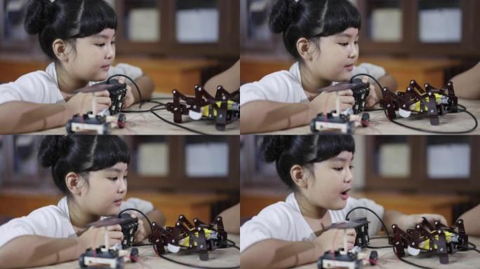 女孩学习在家中构建和固定机器人玩具干研究