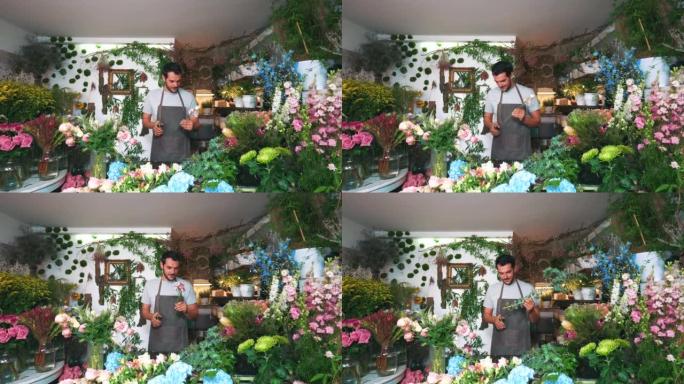 Male florist working in the flower shop.