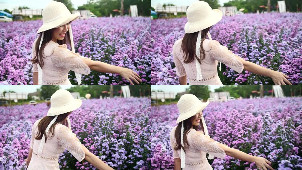 春天，穿着紫色花朵行走的亚洲妇女