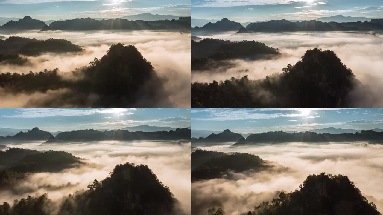 高山上方的空中超流雾和日出时穿过云层的阳光