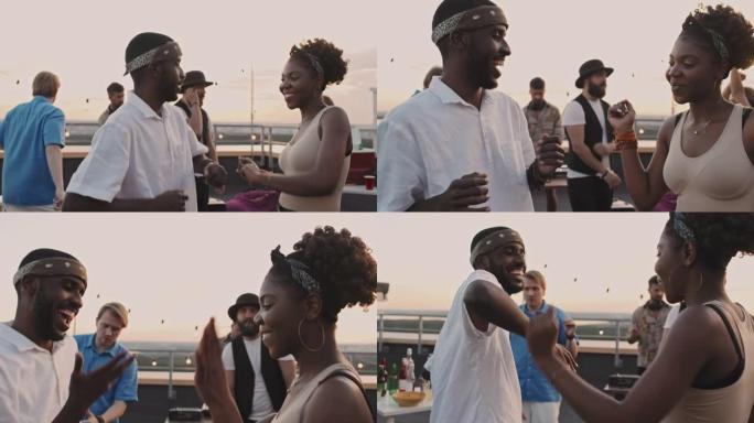 黑人和女人在屋顶露台上的派对上跳舞
