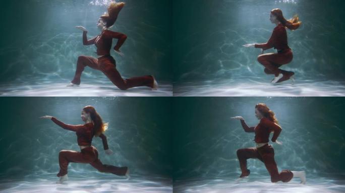 年轻快乐美丽活跃的红发女人玩得开心埃及舞蹈在水下慢动作。