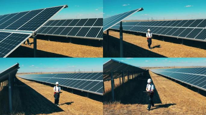 太阳能农场正在接受一名男性专家的检查。节能、能效、可再生能源概念。