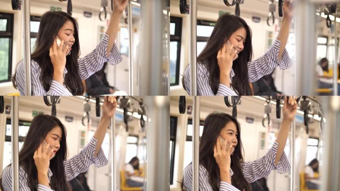 年轻的女商人上班时使用电话在火车上上网