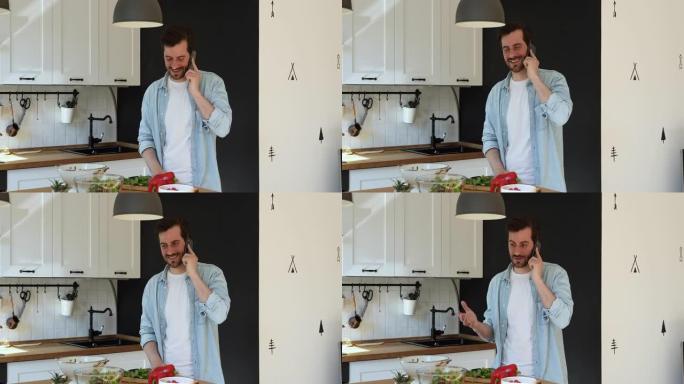 站在厨房里的家伙在智能手机上聊天，分散了烹饪的注意力