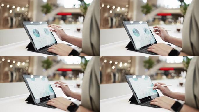 亚洲女商人在咖啡店用笔记本电脑工作