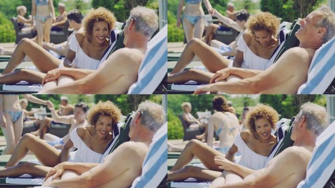 暑假在躺椅上放松的退休高级夫妇在游泳池旁放松