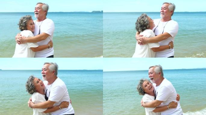 亚洲高级夫妇喜欢在海滩上度过浪漫的假期跳舞