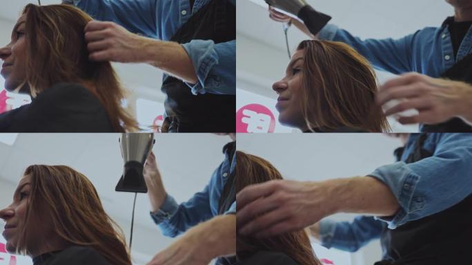 慢动作发型师在美容院为女性顾客干头发