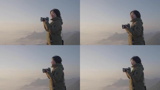 女性背包客无忧无虑地在摄影之旅中捕捉迷雾山的图像。