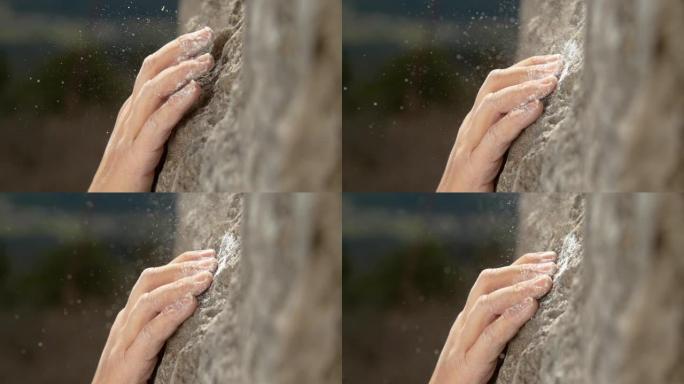宏观: 无法识别的攀岩者用粉笔举起的手抓住了一个倾斜的握杆。