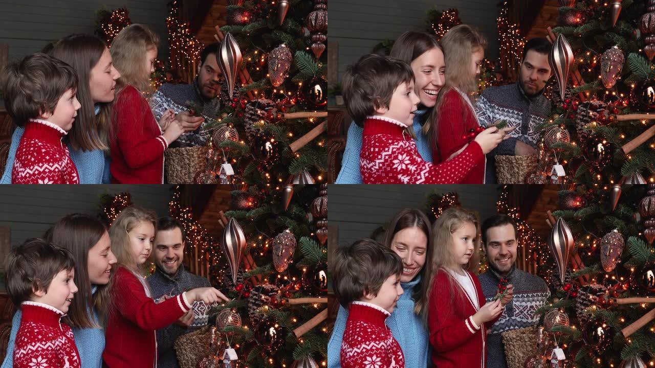 已婚夫妇和孩子们装饰着发光的圣诞树
