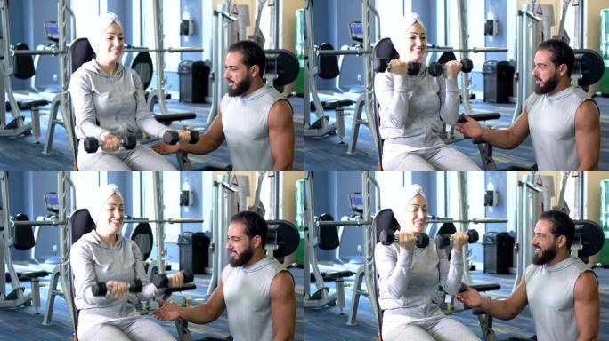 中东夫妇在健身房锻炼，练哑铃