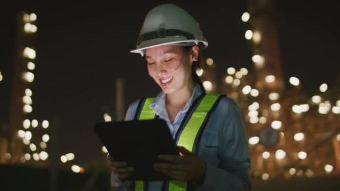 亚洲工程师在夜间在工业上使用平板电脑