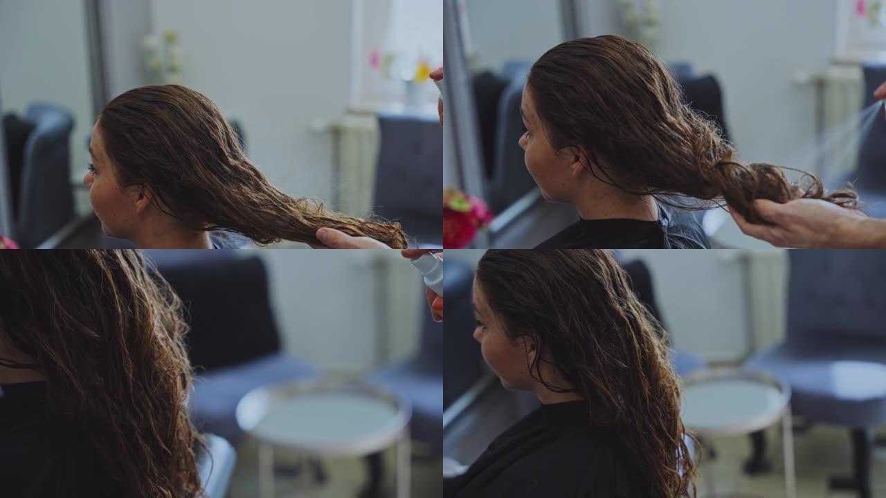 慢动作发型师在沙龙用女性顾客的喷雾来定型头发