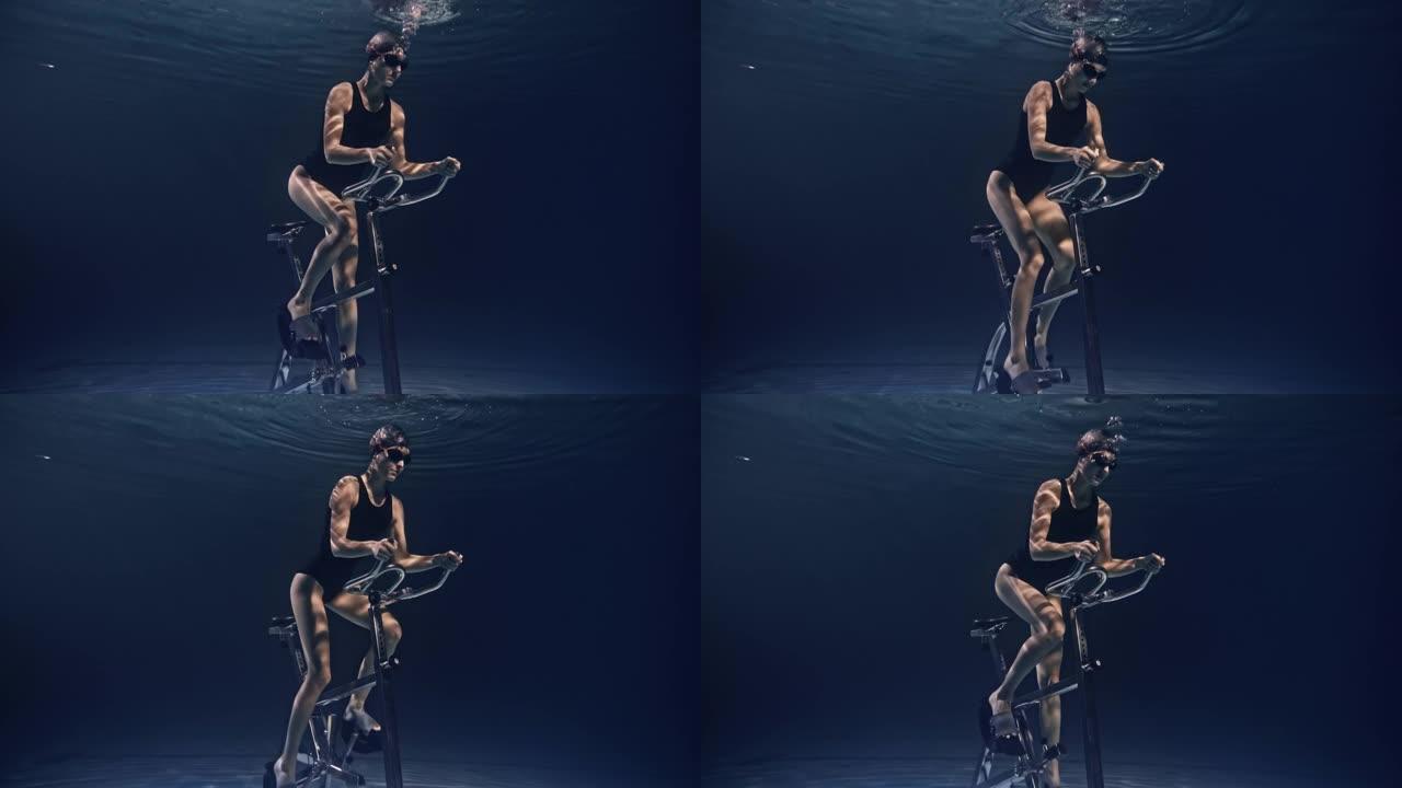 年轻女性运动员身体健康的电影镜头正在水下固定自行车机上努力和决心地锻炼。运动、健身、健康生活方式、娱