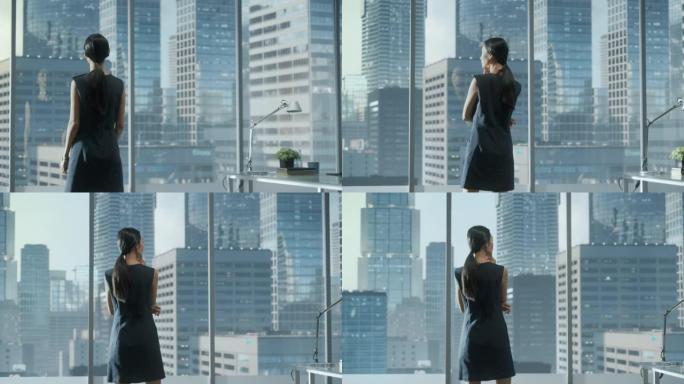 成功的女商人穿着时髦的衣服，看着窗外的大城市在市中心。自信的从事金融项目的女首席执行官。工作计划营销