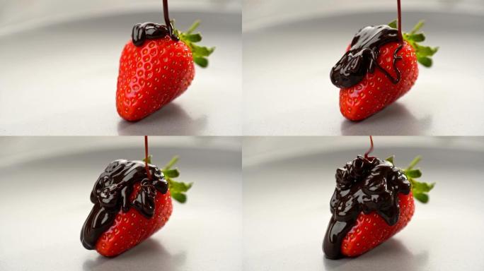 健康的时令食品。鲜红色美味的甜草莓倒入液体巧克力。隔离在灰色板上。滑块镜头，4K