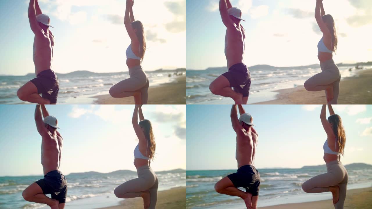 情侣瑜伽在海滩上伸展