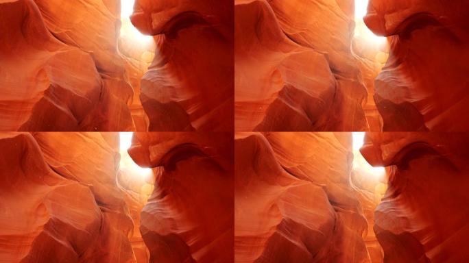 美国亚利桑那州羚羊峡谷橙色砂岩岩石周围漂浮的尘埃。阳光普照。Steadicam镜头，4K