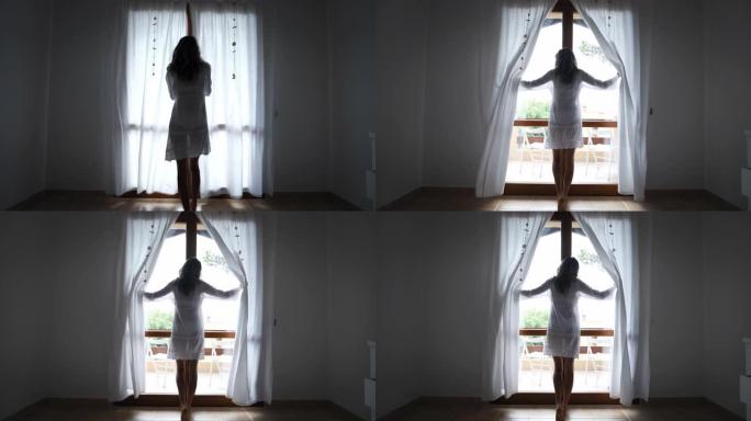 一个穿着白色连衣裙的年轻晒黑的赤脚女人的真实镜头正朝着窗户醒来，早上在酒店房间里拉开窗帘