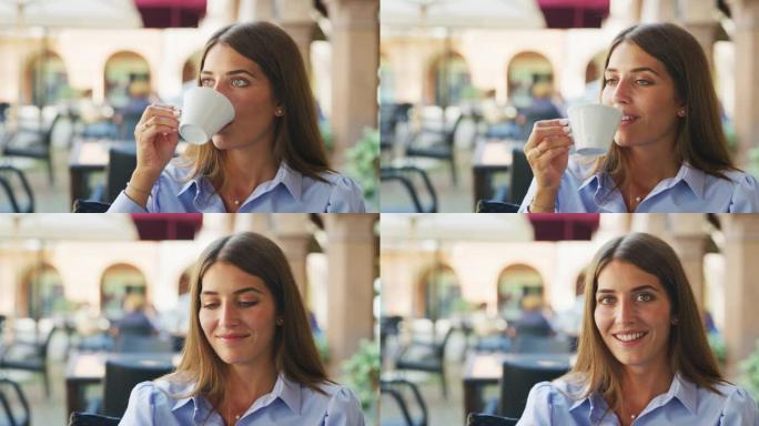 一个年轻女子喝咖啡的真实照片，一边吃新鲜健康的早餐，早上在咖啡馆或酒吧的相机里微笑。