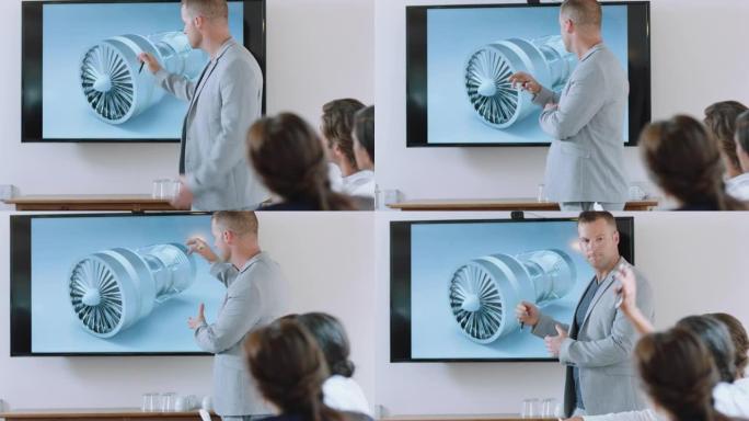 会议室会议的商务人士工程师在电视屏幕上介绍涡轮机设计与同事分享技术简报，讨论办公室演示中的想法