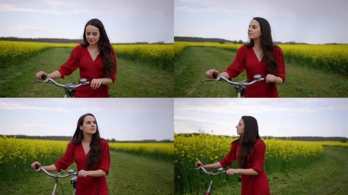 中号，跟踪拍摄了一个穿着红色连衣裙的黑发女郎，她骑着自行车穿过充满金鱼草花朵的草地，慢动作