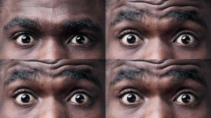 非裔美国人在特写镜头中凝视着相机。眼睑下有睫毛的虹膜和瞳孔的宏观图像。抽象黑人户外角膜和视网膜或隐形