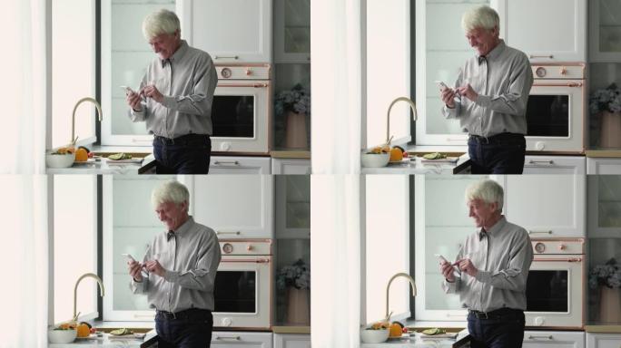 老人在现代厨房中独自使用智能手机