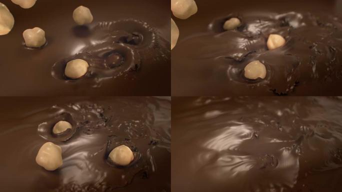 榛子在4k超慢动作中溅到液态牛奶巧克力中