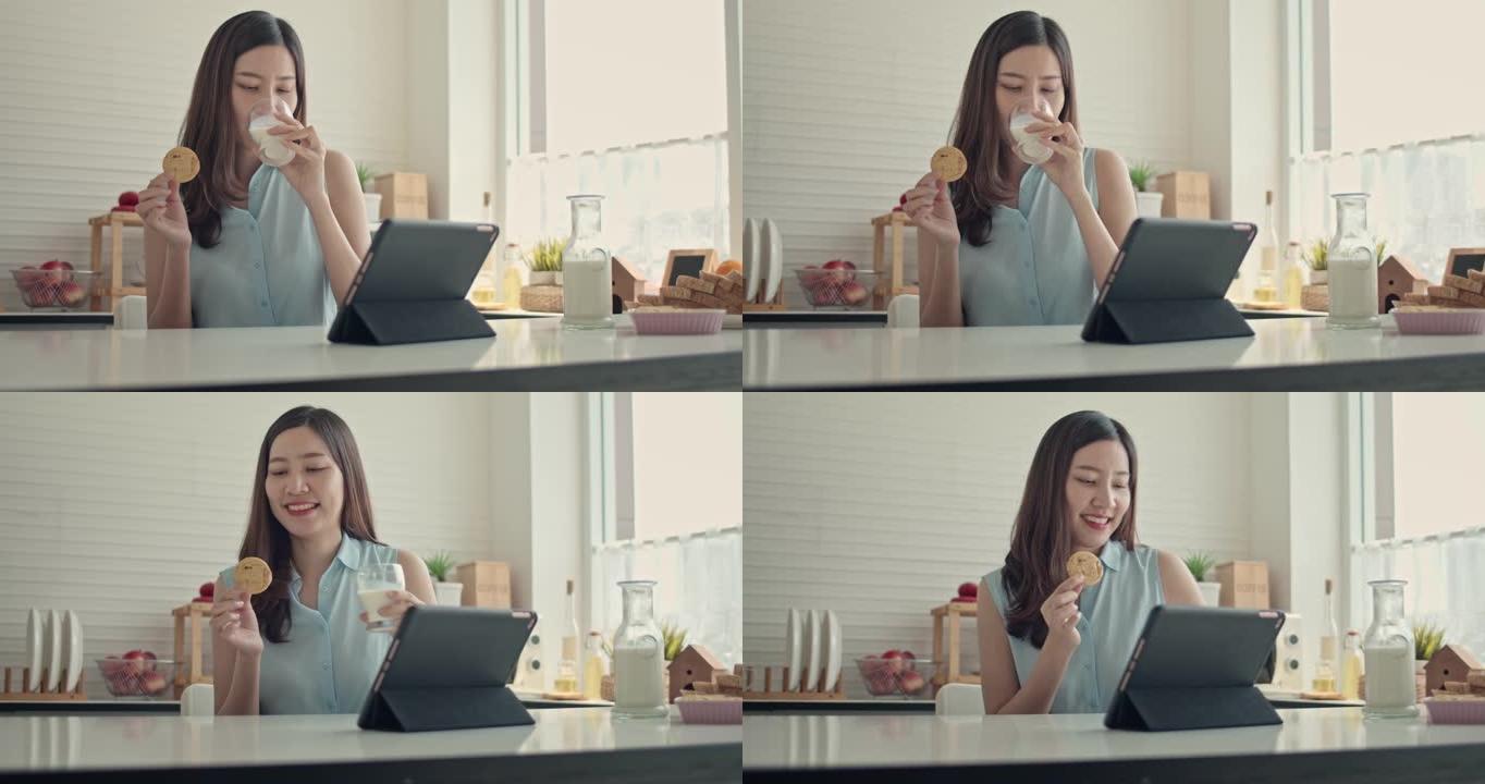 亚洲妇女在厨房中使用数字平板电脑，特写镜头
