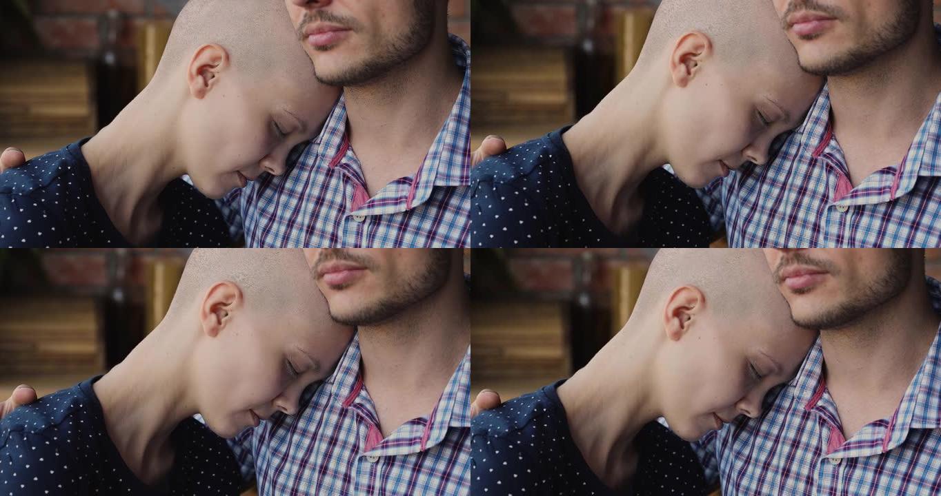 秃头绝望的女性癌症患者将头放在丈夫的肩膀上