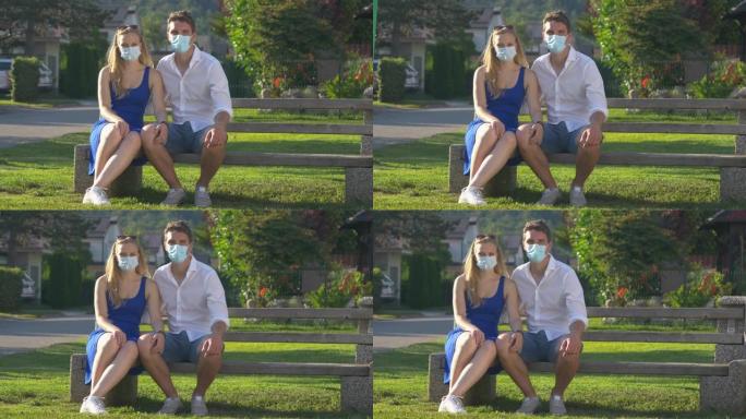 肖像年轻夫妇在新型冠状病毒肺炎大流行期间在公园享受一天。