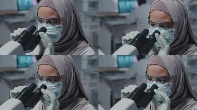 穆斯林实验室技术员使用显微镜