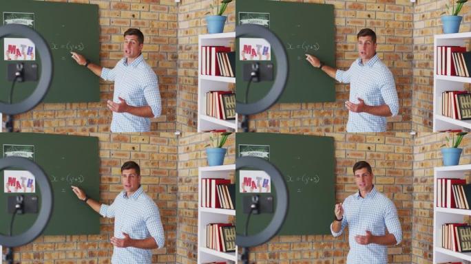 站在黑板上的白人男性数学老师在相机上进行在线课程