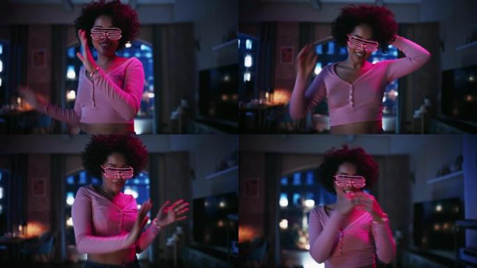 不同的多民族年轻黑人女性的肖像在未来的霓虹灯发光眼镜中跳舞，在阁楼公寓的家中举行派对。为社交媒体录制