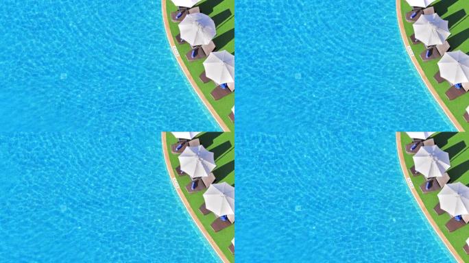 晴天在游泳池中闪耀的蓝水的鸟瞰图背景纹理。