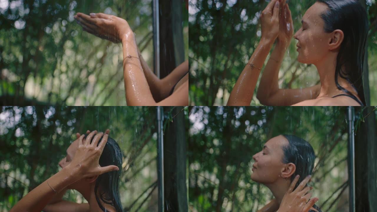 性感的女人在淋浴穿着比基尼洗身体清洁皮肤与清爽的水享受自然美容温泉在大自然的户外淋浴