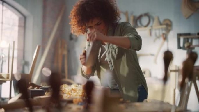 年轻的女工匠木匠用手工飞机塑造木条。在木工车间从事项目的美丽艺术家。