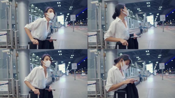 亚洲商务女孩到达目的地戴口罩站在外面看智能手机候车机在国内机场。
