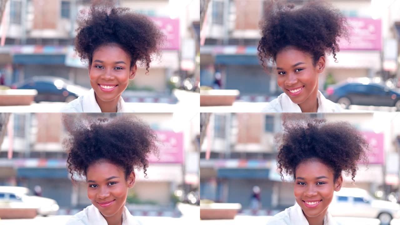 画像美丽的年轻黑人妇女与爆炸头的头发在城市