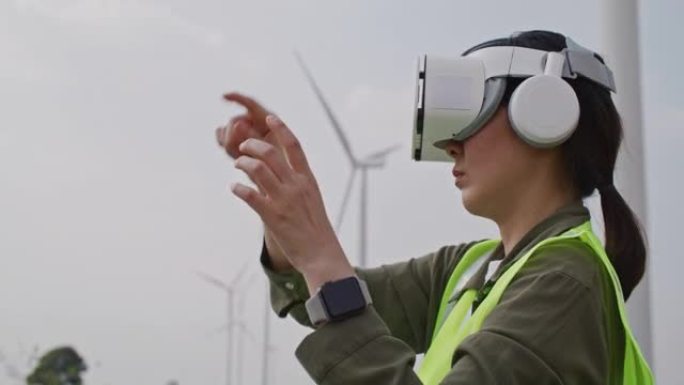 亚洲女工程师戴着虚拟现实耳机，她开发了能量