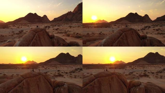 WS摄影师，在日落时分俯瞰沙漠的岩石地层上，非洲纳米比亚
