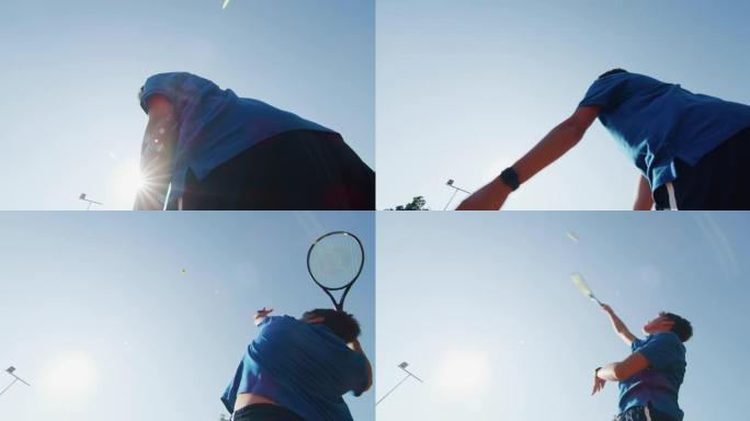 在阳光明媚的日子里，一名年轻的男性青少年网球运动员在球场上打友谊赛或训练锻炼游戏时正在发球。