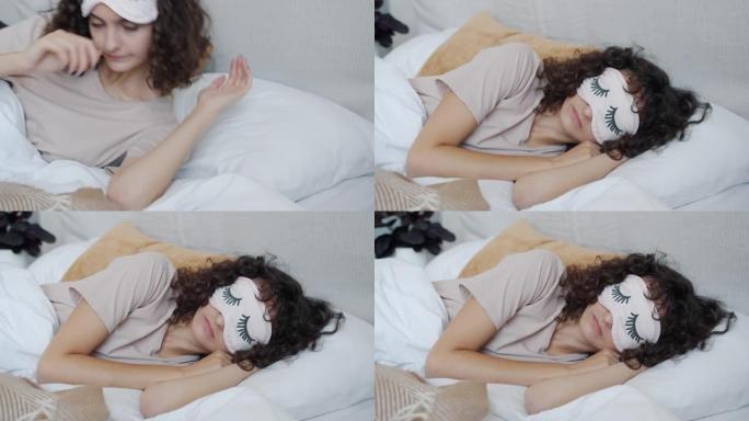 年轻女子戴着眼罩睡觉躺在床上的肖像
