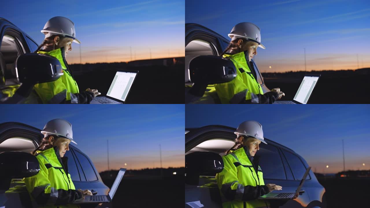 SLO MO Field电工在黄昏时停在乡下某个地方的汽车旁使用她的笔记本电脑