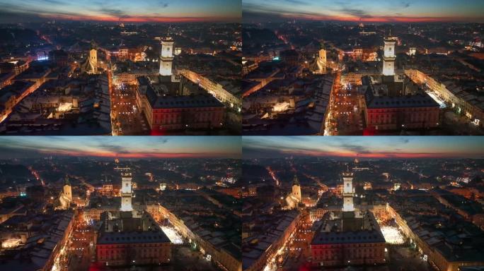 乌克兰利沃夫历史悠久的城市中心壮丽的航拍夜景。背景是市政厅、城市灯光和猩红的夕阳